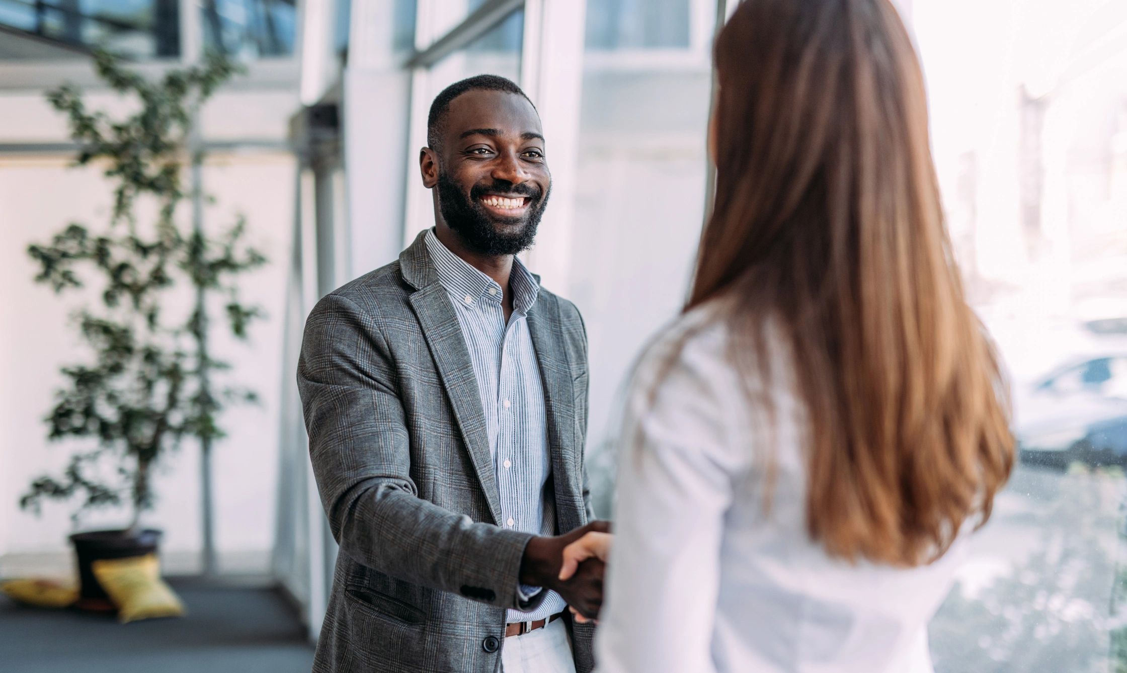 diverse business partners handshake modern office